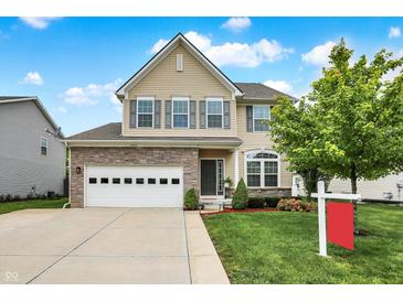 Beautiful two-story home with stone accents, an attached garage, and manicured landscaping at 10306 Mcclain Dr, Brownsburg, IN 46112