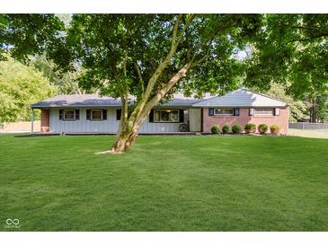 Charming ranch-style home featuring a well-manicured lawn and mature trees at 11802 Prairie Pl, Carmel, IN 46033