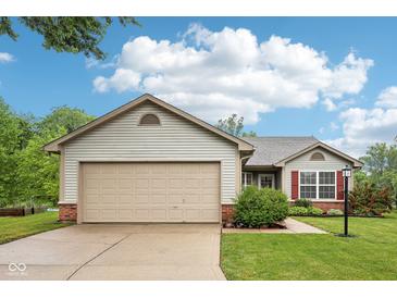 Charming single-story home featuring neutral siding, a two-car garage, and a beautifully landscaped front yard at 12207 Blue Sky Dr, Fishers, IN 46037