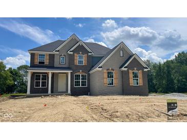 Charming new two-story home showcasing brick and stone accents, complemented by stylish shutters and an inviting front entrance at 1919 Delp Ct, Avon, IN 46123