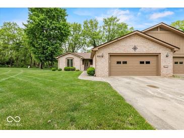 Charming brick home featuring an attached two car garage and a well maintained lawn with mature trees at 3714 Timberview Ct, Anderson, IN 46011