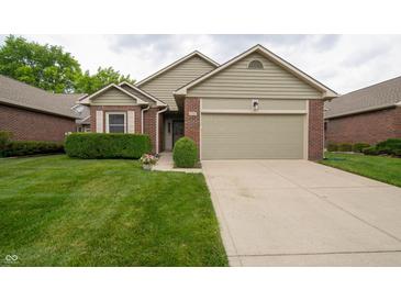 Charming single-story home featuring a brick facade, well-maintained lawn, and attached garage at 5352 Steinmeier N Dr, Indianapolis, IN 46220