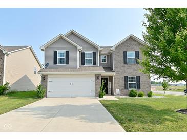 Two-story home with a well-manicured lawn, a two-car garage, and a combination of brick and siding at 680 Albermarle Dr, Pittsboro, IN 46167