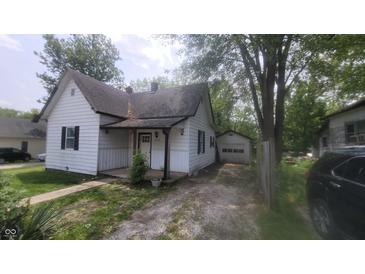 Charming front exterior view of a two-story home with a well-maintained yard and driveway at 7879 Main St, Coatesville, IN 46121