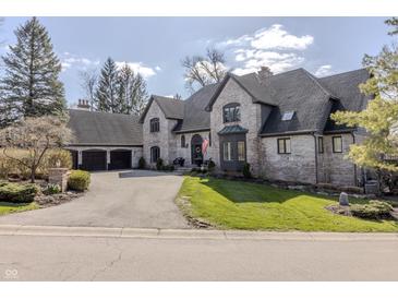 Charming brick home with a manicured lawn and mature trees at 11931 Promontory Ct, Indianapolis, IN 46236