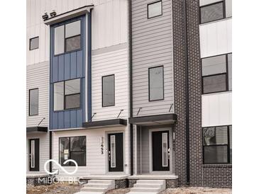 Modern townhouse exterior with black trim windows and a sleek front door, enhancing its curb appeal at 1315 Colere Pl, Indianapolis, IN 46203
