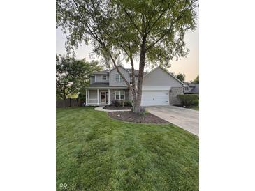 Charming two-story home with brick accents, a well-manicured lawn, and mature shade trees at 1378 Runningbrook Dr, Avon, IN 46123
