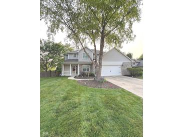 Charming two-story home with a well-manicured lawn, inviting porch, and a two car garage at 1378 Runningbrook Dr, Avon, IN 46123