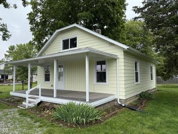 Charming home featuring a covered front porch, well-maintained lawn, and mature landscaping at 204 S Conger St, Saint Paul, IN 47272