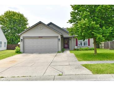 Charming single Gathering home with a well maintained lawn and concrete driveway leading to a two car garage at 3429 Pavetto Ln, Indianapolis, IN 46203