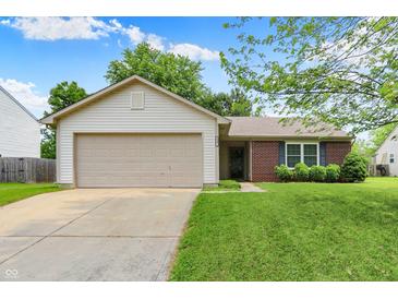 Charming single-story home featuring a brick facade, attached two-car garage, and well-maintained lawn at 4007 Knollwood Ave, Franklin, IN 46131