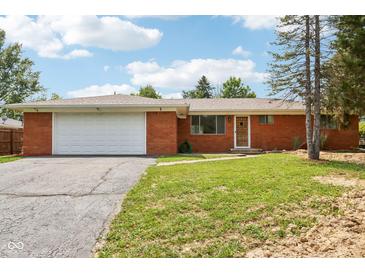 Charming brick ranch-style home featuring an attached two-car garage and a well-maintained front yard at 418 Dunbar Dr, Indianapolis, IN 46229