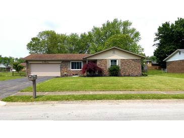 Charming single-story brick home with an attached garage, lush lawn and well-manicured landscaping at 430 Heritage Dr, Danville, IN 46122