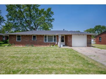 Charming brick home featuring a well-manicured lawn and attached one car garage at 614 Belzer Dr, Anderson, IN 46011