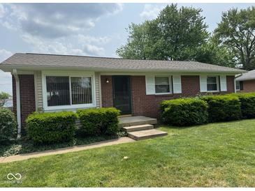 Charming brick ranch-style home with well-manicured lawn and trimmed shrubbery at 705 Orchard Ln, Greenwood, IN 46142