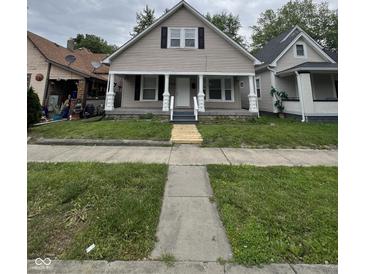 Charming home featuring a covered front porch with decorative columns and a well-maintained lawn at 733 Haugh St, Indianapolis, IN 46222