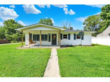 Charming single-story home with a covered front porch and a lovely swing for relaxing at 7455 W 700 N, Fairland, IN 46126