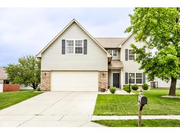 Charming two-story home with a well-manicured lawn and attached two-car garage at 7546 Kidwell Dr, Indianapolis, IN 46239