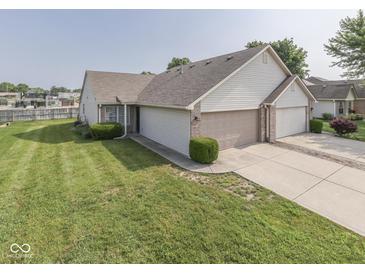 Well-maintained home featuring a two-car garage, manicured lawn, and charming curb appeal at 824 Ashton Park Dr, Greenwood, IN 46143