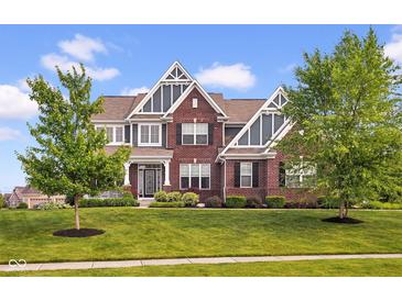 Beautiful two-story brick home with landscaped front yard and mature trees at 1313 Brentford Ln, Greenwood, IN 46143