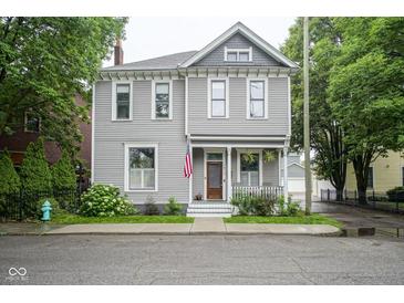 Charming two-story home featuring a classic design, inviting porch, and well-maintained landscaping at 1512 Bellefontaine St, Indianapolis, IN 46202