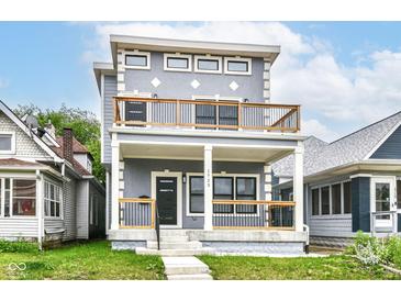 Inviting two-story home with a gray exterior, balcony, and well-maintained front yard at 1723 Fletcher Ave, Indianapolis, IN 46203