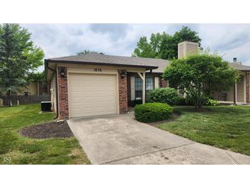 Cozy single Gathering home featuring an attached garage and well maintained front lawn at 1836 Queensbridge Cir, Indianapolis, IN 46219