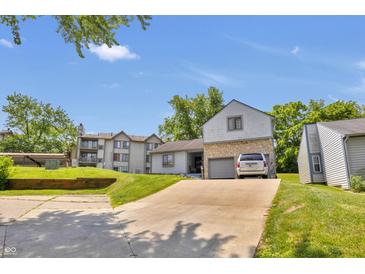 Two story home featuring a two-car garage, driveway and lawn at 2925 Horse Hill East Dr, Indianapolis, IN 46214