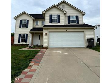 Two-story home featuring a two car garage, black shutters, and a well-manicured lawn at 3065 Hemlock Way, Indianapolis, IN 46203