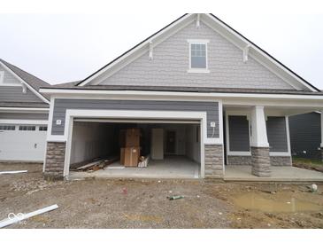 New construction features a two-car garage and stone accents on the gray exterior at 3599 Hauser Ct, Bargersville, IN 46106