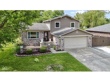 Charming two-story home with brick accents, well-maintained lawn, and attached two-car garage at 4718 Dancer Dr, Indianapolis, IN 46237
