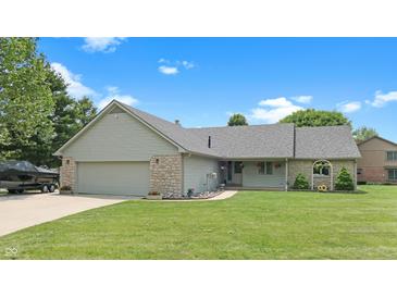 Charming ranch-style home featuring a manicured lawn, stone accents, and an attached two-car garage at 5431 Nathan Pl, Indianapolis, IN 46237
