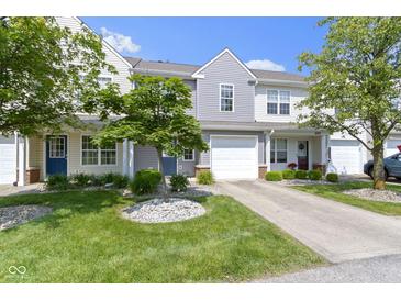 Charming townhouse with attached garage, landscaped front yard, and a tree in a bed of rocks at 603 Daviess Dr, Westfield, IN 46074