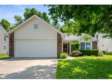 Charming single-Gathering home with a two-car garage, complemented by a lush green lawn and mature trees at 6963 N Abilene Way, McCordsville, IN 46055