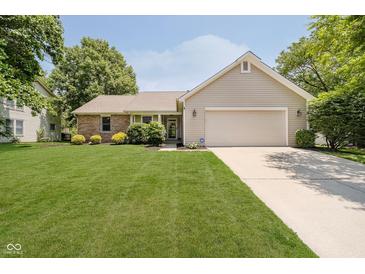 Charming single-story home featuring a well-maintained lawn, manicured landscaping, and an attached two-car garage at 9363 Hadway Dr, Indianapolis, IN 46256