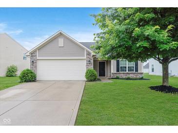 Charming home featuring a two-car garage, well-maintained lawn, and mature tree, enhancing curb appeal at 11521 Short Iron Ln, Indianapolis, IN 46235