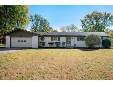Charming single-story home featuring a two-car garage and a well-maintained front yard at 1325 Alimingo Dr, Indianapolis, IN 46260