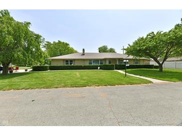 Charming one-story brick home with manicured lawn and mature trees, offering great curb appeal at 1910 Ivy Dr, Anderson, IN 46011