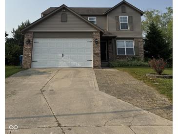 Traditional two-story home with a two-car garage, neutral siding, and a well-maintained front yard at 2540 Lullwater Ln, Indianapolis, IN 46229