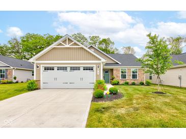 Charming single-story home features manicured lawn, stone accents, and a two-car garage at 2747 Stonebridge Dr, Lebanon, IN 46052