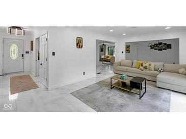Open-concept living area with sleek marble flooring, modern decor, and seamless flow for entertaining at 3141 Citadel Ct, Indianapolis, IN 46268