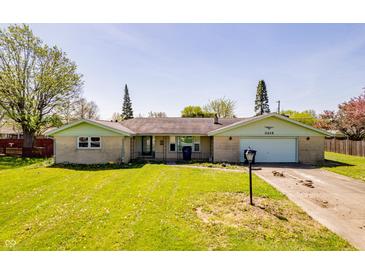 Charming single-story brick home with a well-maintained lawn and attached garage at 3215 E 10Th St, Anderson, IN 46012