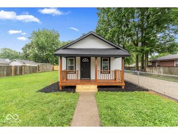 Charming single-story home featuring a cozy front porch and well-manicured lawn at 3453 W 12Th St, Indianapolis, IN 46222