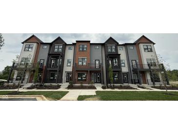 New townhouses showcase modern architecture, complete with brick accents and individual balcony spaces at 449 Shade St, Carmel, IN 46290