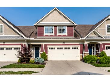 Charming townhome featuring a two-car garage, manicured landscaping, and a well-maintained facade at 478 Firefly Ln, Carmel, IN 46032