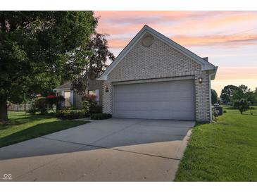 Charming brick home with a two-car garage and well-maintained landscaping at 7456 Jack Pine Ct, Avon, IN 46123