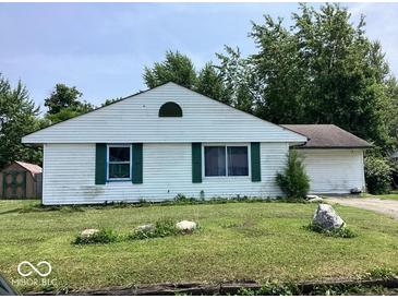 Single-story home showcasing classic white siding and green shutters at 9925 Catalina Dr, Indianapolis, IN 46235