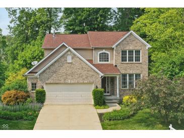 Charming two-story home with brick and siding exterior and well-maintained landscaping at 10402 Shakamak Way, Indianapolis, IN 46239