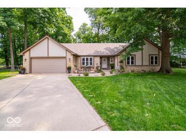 Charming single-story home featuring a well-manicured lawn and stone facade at 1304 Old Hickory Cir, Greenwood, IN 46142
