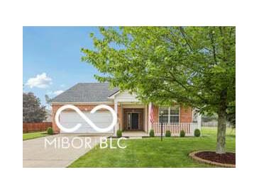Charming single story home features a two-car garage and a welcoming covered porch at 19146 Carol Cove Cir, Noblesville, IN 46062